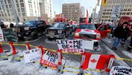 Signs sit on a police baracade as truckers and their supporters continue to protest coronavirus disease (COVID-19) vaccine mandates, in Ottawa, Ontario, Canada, February 7, 2022. REUTERS/Patrick Doyle
