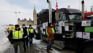 Police had out information sheets and speak to demonstrators as truckers and supporters continue to protest coronavirus disease (COVID-19) vaccine mandates, in Ottawa, Ontario, Canada, February 16, 2022. REUTERS/Blair Gable
