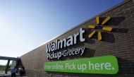People talk outside a Walmart Pickup-Grocery test store in Bentonville, Arkansas, June 4, 2015. REUTERS/Rick Wilking/File Photo