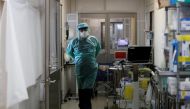 A medical worker wearing personal protection equipment (PPE) walks inside the Intensive Care Unit (ICU) ward at St. Marianna University Yokohama Seibu Hospital where patients suffering from the coronavirus disease (COVID-19) are being treated in Yokohama, south of Tokyo, Japan May 25, 2021. REUTERS/Issei Kato/File Photo

