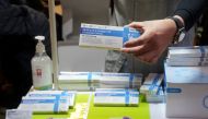 A promoter holds a box of rapid antigen test kit for the coronavirus disease (COVID-19) at a street stall in Hong Kong, China February 22, 2022. REUTERS/Lam Yik