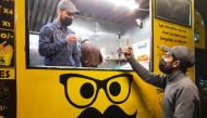 People communicate using sign language outside Pakistan's first mobile restaurant, staffed entirely by deaf workers, in Islamabad, Pakistan February 23, 2022. Picture taken February 23, 2022. REUTERS/Salahuddin NO RESALES. NO ARCHIVES.
