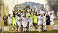 Al Sadd players and officials celebrate with the Falcon Shield after being crowned the QNB Stars League champions. 