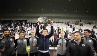 Al Sadd coach Javi Gracia celebrates with the supporting staff members. 