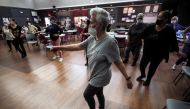 Seniors dance together during Walter Perez's dance class at the YM & YWHA of Washington Heights and Inwood, where he gives an audience of older adults an opportunity to socialize, stay fit and enjoy the music from their past, during the coronavirus (COVID-19) pandemic in New York City, New York, U.S. March 7, 2022. REUTERS/Mike Segar