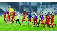 Al Duhail players celebrate with coach Luis Castro after defeating Al Sadd to reach the Amir Cup final, yesterday.