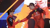 Ferrari's Charles Leclerc celebrates on the podium after winning the race with second place Ferrari's Carlos Sainz Jr. REUTERS/Thaier Al-Sudani
