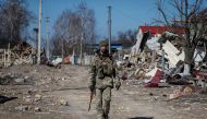 A Ukrainian service member walks, as the Russian invasion continues, in a destroyed village on the front line in the east Kyiv region, Ukraine March 21, 2022. REUTERS/Gleb Garanich



