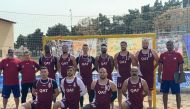 Qatar national beach handball team players and officials pose for a photograph on the eve of their opening match against the Philippines in Tehran. 