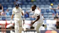 West Indies' Kyle Mayers celebrates after taking the wicket of England's Joe Root Action Images via Reuters/Jason Cairnduff
