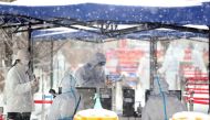 A resident prepares to get tested amid the snow at a nucleic acid testing site, following the coronavirus disease (COVID-19) outbreak in Changchun, Jilin province, China March 15, 2022. China Daily via REUTERS



