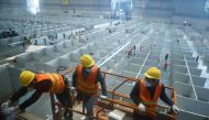 Workers labour to convert the National Exhibition and Convention Center into a makeshift hospital for the coronavirus disease (COVID-19), in Shanghai, China April 7, 2022. cnsphoto via Reuters