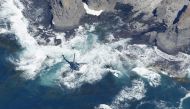 A helicopter searches for missing people onboard the tour boat 