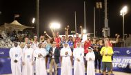 Qatar Volleyball Association President Ali Ghanim Al Kuwari and officials pose for a photograph with the men's and women's podium winners of the Volleyball World Beach Pro Tour Doha Challenge at the Al Gharafa Beach Courts yesterday.