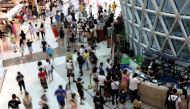 People wearing face masks following the coronavirus disease (COVID-19) outbreak shop at the Sanya International Duty-Free Shopping Complex in Sanya, Hainan province, China November 25, 2020. Picture taken November 25, 2020. REUTERS/Tingshu Wang
