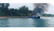 Smoke rises from a burning passenger vessel near Real, Quezon province, May 23, 2022. Philippine Coast Guard/Handout via REUTERS