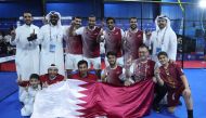 Qatar padel players and officials celebrate after winning the gold medal.