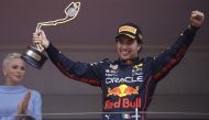 Red Bull's Sergio Perez celebrates with a trophy on the podium after winning the race as Princess Charlene of Monaco applauds REUTERS/Christian Hartmann
