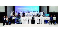 Qatar Olympic Committee (QOC) officials and participants of the volunteers promotional workshop pose for a photograph at the QOC Headquarters.