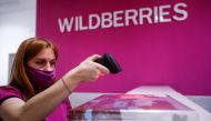 FILE PHOTO: An employee of Wildberries online retailer scans a code on a package at a pickup point in Moscow, Russia December 16, 2021. Picture taken December 16, 2021. REUTERS/Maxim Shemetov/File Photo
