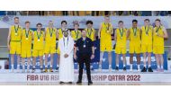Qatar Basketball Federation President Mohammed Saad Al Mughaiseeb with the victorious Australia team players and coach Justin Schueller.