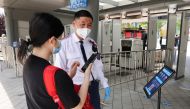 A security guard checks nucleic acid test result for a tourist at an entrance to the Universal Beijing Resort in Beijing, China June 25, 2022. Reuters/Tingshu Wang