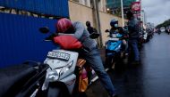 A man waits in a queue to buy petrol due to fuel shortage, amid the country's economic crisis, in Colombo, Sri Lanka, June 16, 2022. REUTERS/Dinuka Liyanawatte/File Photo


