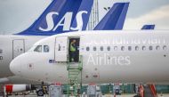 A technician works aboard a SAS Airbus A320neo at Kastrup Airport after pilots of Scandinavian Airlines went on strike, in Kastrup, Denmark, July 4, 2022. (Reuters)

