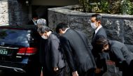 Japanese lawmaker Sanae Takaichi prays to the vehicle believed to be carrying the body of former Japanese Prime Minister Shinzo Abe, who was shot while campaigning for a parliamentary election, at his residence in Tokyo, Japan July 9, 2022. (REUTERS/ Kim Kyung-Hoon)