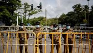 Security personel stand guard outside the Parliament building, amid the country's economic crisis, in Colombo, Sri Lanka July 16, 2022. REUTERS/Adnan Abidi


