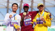 Gold Medallist Qatar’s Mutaz Essa Barshim celebrates on the podium alongside silver medallist Woo Sanghyeok  of South Korea and bronze medallist Andriy Protsenko of Ukraine during the medal ceremony.