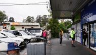 Customers queue outside a Western Sydney chemist to purchase Rapid Antigen Test kits in the wake of the coronavirus disease (COVID-19) pandemic in Sydney, Australia, January 5, 2022. REUTERS/Jaimi Joy

