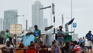 Protesters gather near the Presidential Secretariat after a raid on an anti-government protest camp early on Friday, amid the country's economic crisis, in Colombo, Sri Lanka July 22, 2022. (REUTERS/Adnan Abidi)