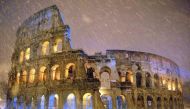 The ancient Colosseum is seen during heavy snowfalls late at night in Rome on February 4, 2012. (REUTERS/Gabriele Forzano)