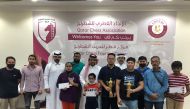 The trophy winners of the Open Blitz Chess Championship pose for a photograph with the officials.