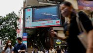 A TV screen shows China's People's Liberation Army has begun military exercises including live firing in the waters and airspace surrounding the island of Taiwan, in Hong Kong, China August 4, 2022. Reuters/Tyrone Siu