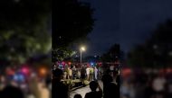 People walk towards emergency vehicles after a shooting at the Six Flags Great America amusement park in Gurnee, Illinois, U.S., August 14, 2022, in this screengrab obtained from a social media video. Jack/via REUTERS