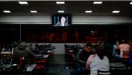 A television screen displays an image of Brazil's President and re-election candidate Jair Bolsonaro while he gives an interview on TV Globo's Jornal Nacional, at a bar on the outskirts of Brasilia, on August 22, 2022. REUTERS/Ueslei Marcelino