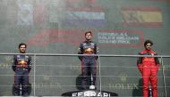 Red Bull's Max Verstappen celebrates on the podium after winning the Belgian Grand Prix with second placed Red Bull's Sergio Perez and third placed Ferrari's Carlos Sainz Jr. at the Spa-Francorchamps, in Spa, Belgium on August 28, 2022.  REUTERS/Johanna Geron