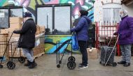 Residents wait to pick up food boxes at the nonprofit New Life Centers' food pantry in Chicago, Illinois, U.S. March 16, 2021. Picture taken March 16, 2021. REUTERS/Daniel Acker

