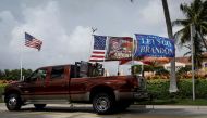 A vehicle with flags supporting former President Donald Trump is seen near his Mar-a-Lago home after he said that FBI agents raided it, in Palm Beach, Florida, on August 9, 2022.  REUTERS/Marco Bello