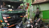 Police officers try to move a damaged truck after an accident in Bekasi, on the outskirts of Jakarta, Indonesia, August 31, 2022, in this photo taken by Antara Foto. Antara Foto/Fakhri Hermansyah/ via REUTERS