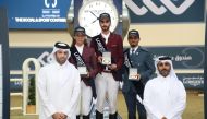 Sheikh Ahmed bin Noah Al Thani, Member, Higher Organising Committee Longines Hathab Sixth Edition, and Faisal bin Abdulhadi Al Marri, Assistant Tournament Director, with the winners of the Big Tour class of Longines Hathab opening round at the Qatar Equestrian Federation’s Indoor Arena yesterday.