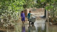 Men move their belongings as they clear up their house, following rains and floods during the monsoon season in Nowshera, Pakistan September 4, 2022. REUTERS/Fayaz Aziz