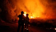 Firefighters respond as the Fairview Fire burns near Hemet, California, U.S., September 5, 2022. REUTERS/David Swanson