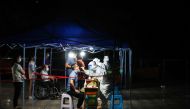 Medical workers in protective suits collect swabs from residents at a nucleic acid testing site following the coronavirus disease (COVID-19) outbreak in Guiyang, Guizhou province, China September 9, 2022. cnsphoto via REUTERS