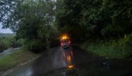 An ambulance drives through a wet rural road as Hurricane Fiona and its heavy rains approaches in Guayanilla, Puerto Rico, on September 18, 2022. (REUTERS/Ricardo Arduengo)