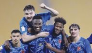 Al Duhail's Michael Olunga (centre) celebrates with team-mates after scoring a hat-trick against Al Markhiya, yesterday.