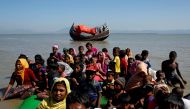 File Photo: Rohingya refugees sit on a makeshift boat as they get interrogated by the Border Guard Bangladesh after crossing the Bangladesh-Myanmar border, at Shah Porir Dwip near Cox's Bazar, Bangladesh, on November 9, 2017. (REUTERS/Navesh Chitrakar)