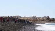 Members of Syrian Red Crescent work by a shoreline following a migrant boat, which according to Lebanese and Syrian officials, sank off the Syrian coast after sailing from Lebanon, in Tartous, Syria September 24, 2022. Courtesy of Syrian Red Crescent